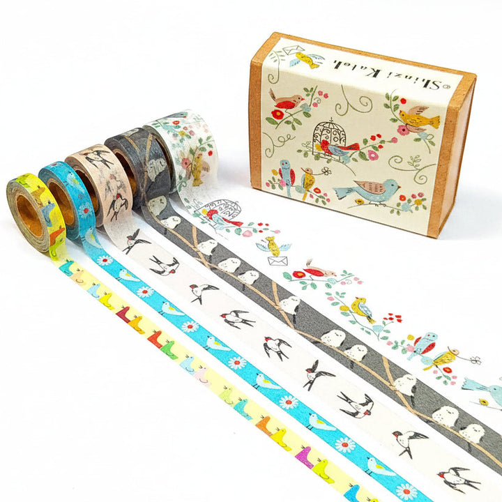 Set of washi tape rolls with bird designs and a decorative box on a white background.